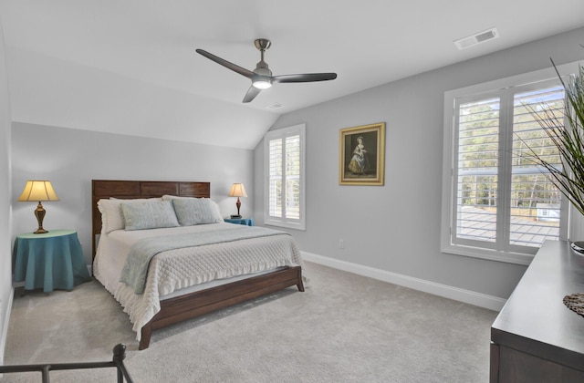 carpeted bedroom with ceiling fan and lofted ceiling