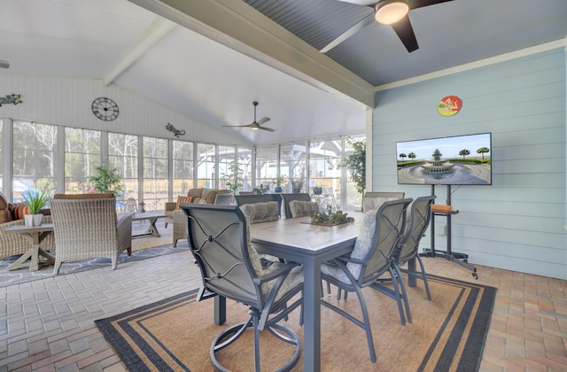 sunroom / solarium featuring a wealth of natural light, lofted ceiling with beams, and ceiling fan