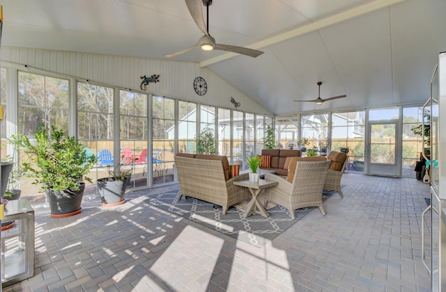 sunroom / solarium featuring lofted ceiling with beams and ceiling fan