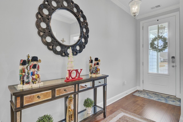 foyer featuring wood-type flooring and ornamental molding