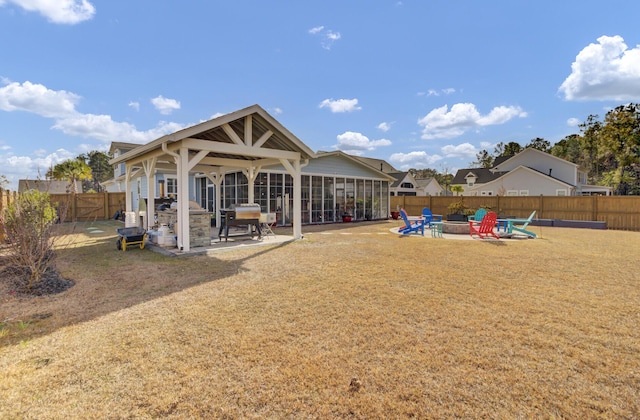 back of property with a fire pit and a patio area