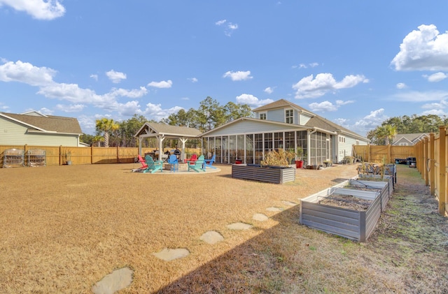 view of play area with a gazebo, a pool, and a sunroom