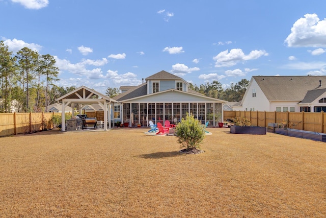 back of house with a gazebo and a sunroom