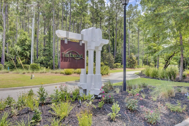 community sign featuring a lawn