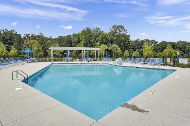 view of swimming pool with a patio area and a pergola