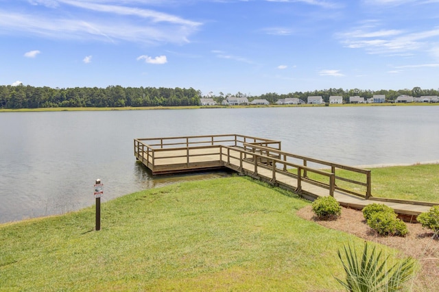 view of dock with a water view and a lawn