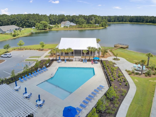 view of pool with a water view and a patio