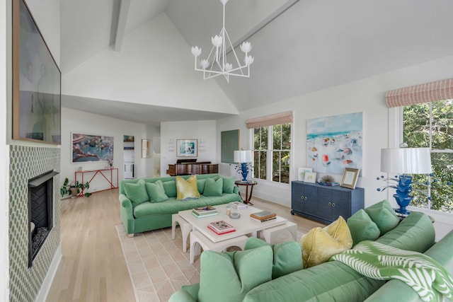 living room with a tiled fireplace, high vaulted ceiling, plenty of natural light, and light wood-type flooring