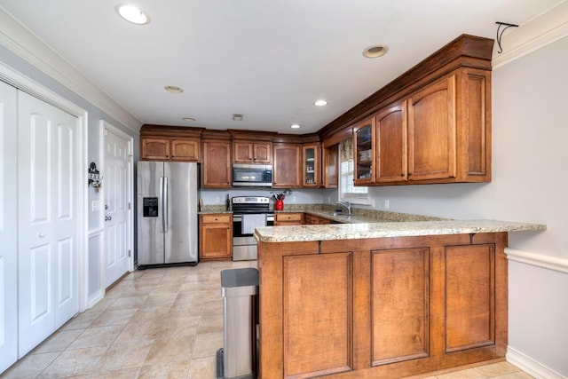 kitchen with glass insert cabinets, brown cabinetry, stainless steel appliances, and a peninsula