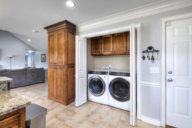 washroom featuring recessed lighting, cabinet space, light tile patterned flooring, and washer and dryer