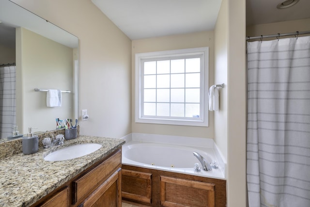 full bath featuring a whirlpool tub, a shower with shower curtain, and vanity