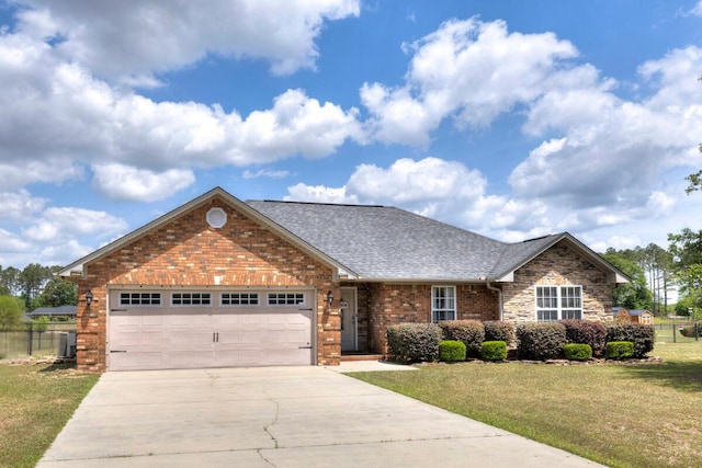 ranch-style home with a front yard, a garage, brick siding, fence, and concrete driveway