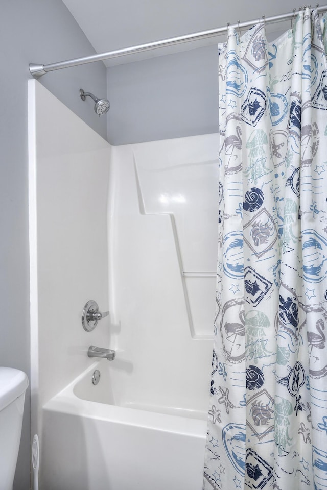bathroom with toilet and shower / bath combination with curtain