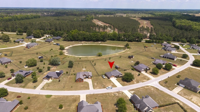 drone / aerial view with a view of trees and a water view