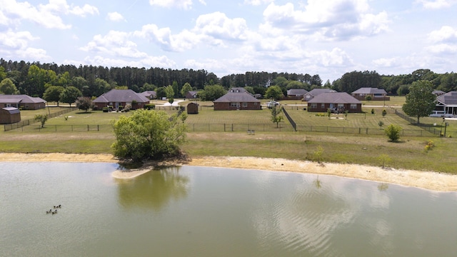 view of water feature with fence and a wooded view