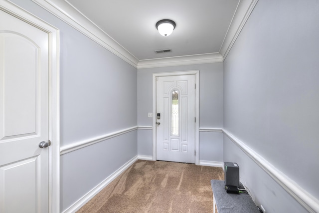 entryway with carpet flooring, crown molding, visible vents, and baseboards