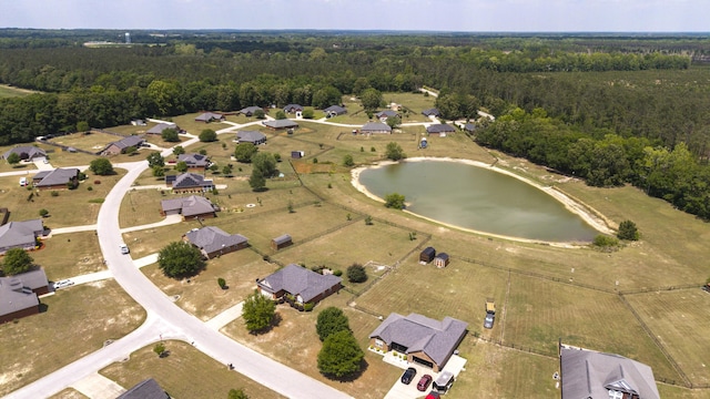 drone / aerial view with a water view and a wooded view