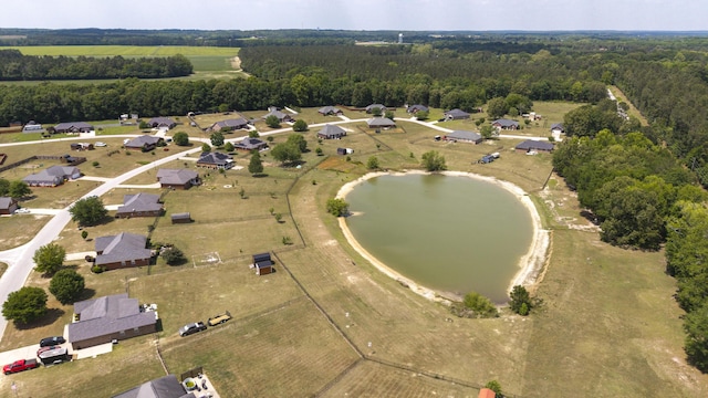 birds eye view of property with a water view and a wooded view