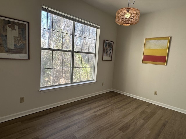 spare room with dark wood-type flooring