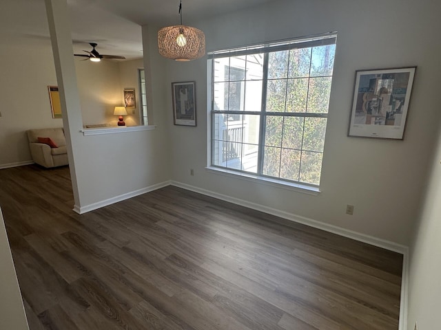 unfurnished dining area with dark wood-type flooring and ceiling fan