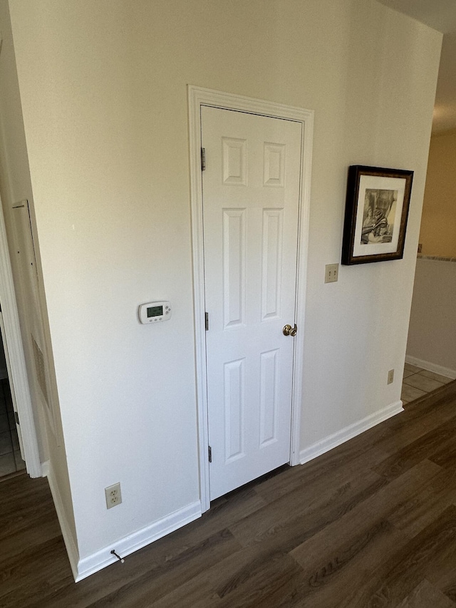 hallway featuring dark hardwood / wood-style flooring