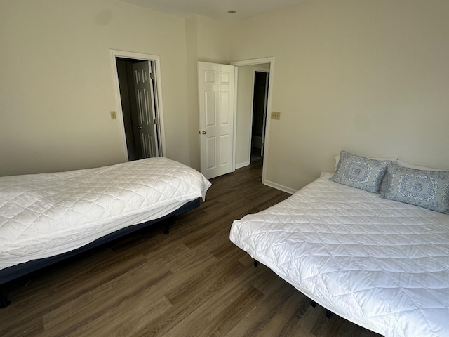 bedroom with dark hardwood / wood-style flooring