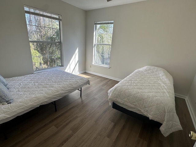 bedroom with dark hardwood / wood-style floors