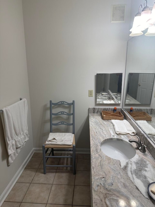 bathroom featuring tile patterned flooring and vanity