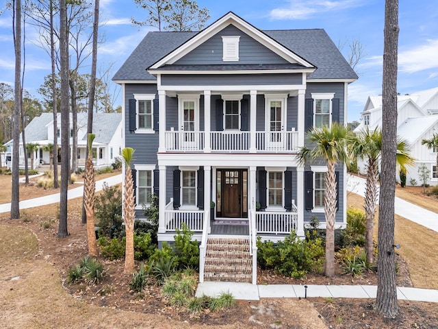 view of front of home featuring covered porch and roof with shingles