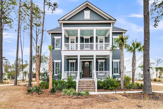 view of front of property with a balcony, covered porch, and a shingled roof