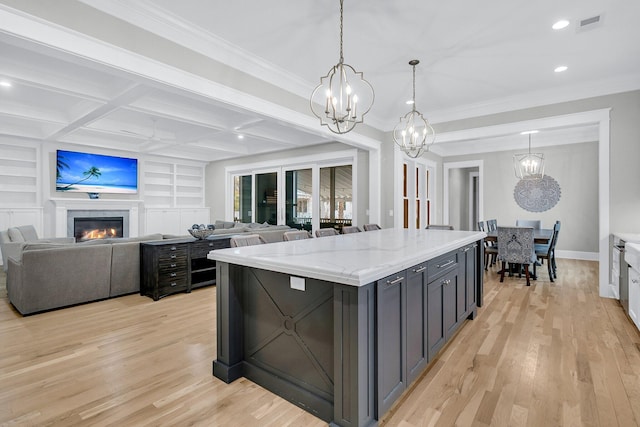 kitchen featuring built in features, coffered ceiling, light wood-type flooring, and open floor plan