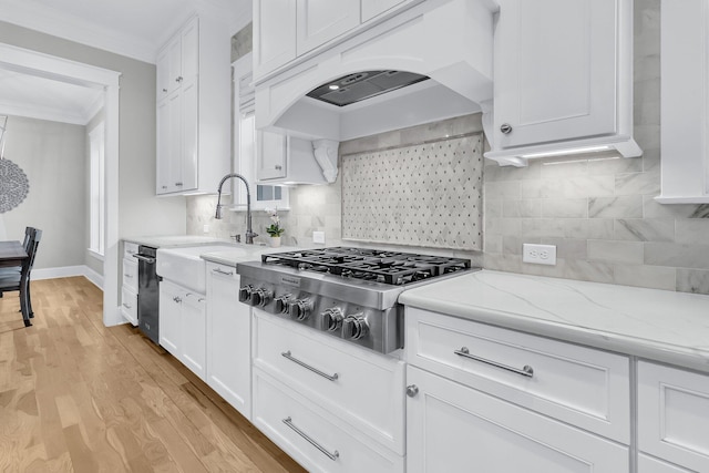 kitchen featuring ornamental molding, white cabinetry, light wood-style floors, custom exhaust hood, and stainless steel gas cooktop