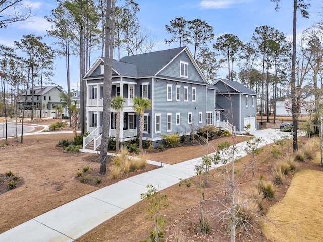 view of front of home featuring a balcony, covered porch, and a shingled roof