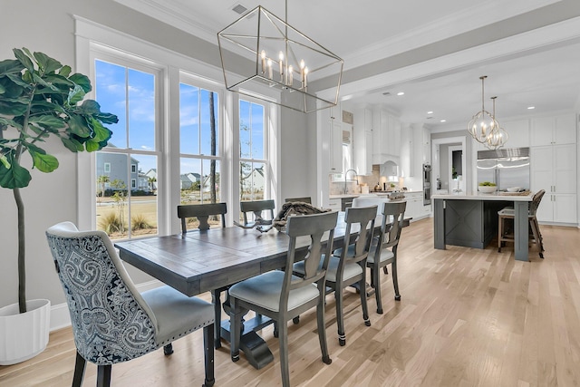 dining area with recessed lighting, light wood-type flooring, a chandelier, and ornamental molding