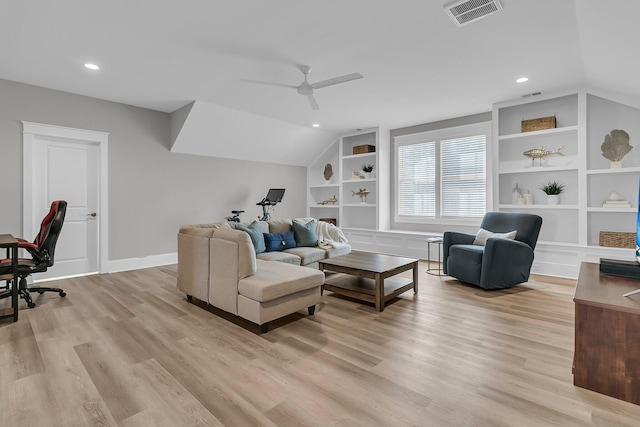 living area with built in shelves, baseboards, visible vents, lofted ceiling, and light wood-style flooring