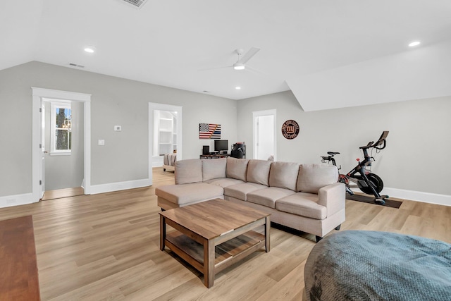 living room with baseboards, light wood-style floors, lofted ceiling, and a ceiling fan