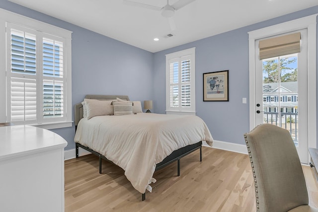 bedroom with visible vents, baseboards, light wood-style floors, and access to outside