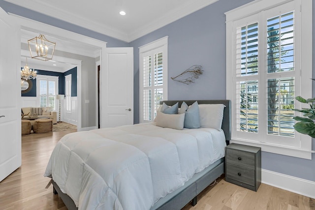 bedroom featuring a notable chandelier, recessed lighting, light wood-style floors, crown molding, and baseboards