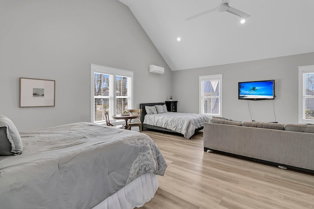 bedroom with a wall mounted air conditioner, recessed lighting, light wood-style floors, high vaulted ceiling, and a ceiling fan