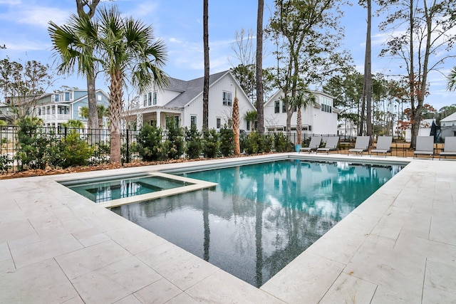 view of pool featuring a patio, fence, and a residential view