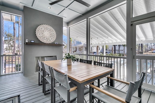 dining space featuring beamed ceiling, a healthy amount of sunlight, and a ceiling fan