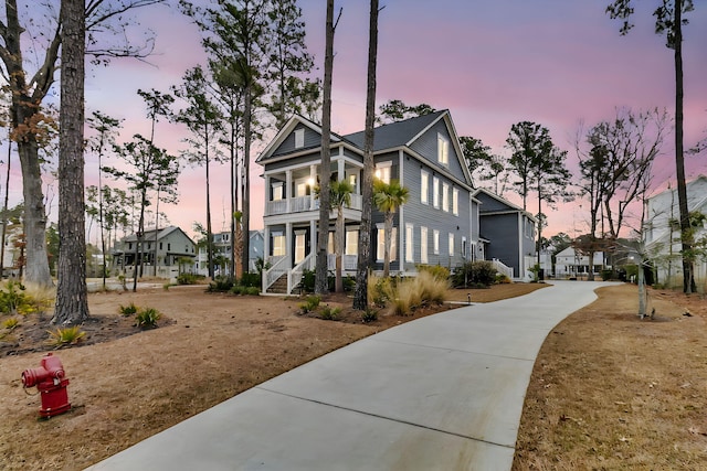 view of front facade with a balcony and covered porch