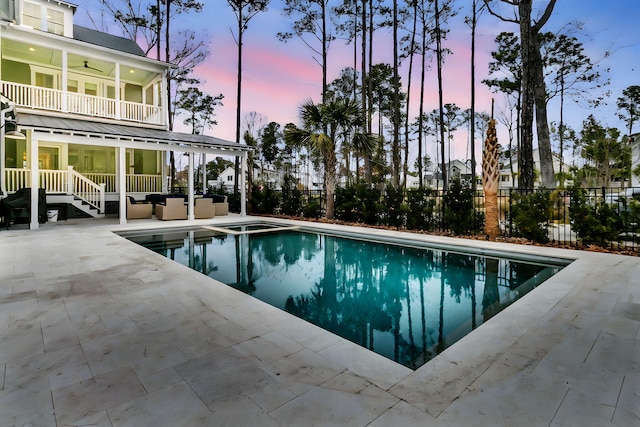 view of pool with a ceiling fan, an outdoor living space, a patio, fence, and a fenced in pool