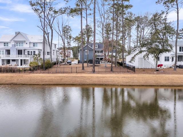 property view of water with a residential view and fence