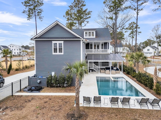 back of house featuring a patio, a fenced in pool, a fenced backyard, stairs, and an outdoor hangout area