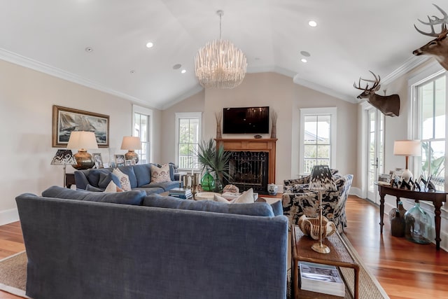 932 Middle St, Sullivans Island, SC 29482 - living area with plenty of natural light, vaulted ceiling, wood finished floors, a chandelier, and ornamental molding