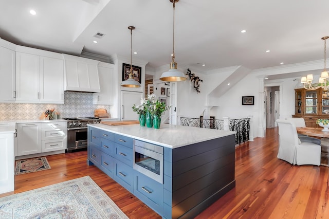 932 Middle St, Sullivans Island, SC 29482 - kitchen with appliances with stainless steel finishes, white cabinetry, blue cabinetry, custom range hood, and crown molding