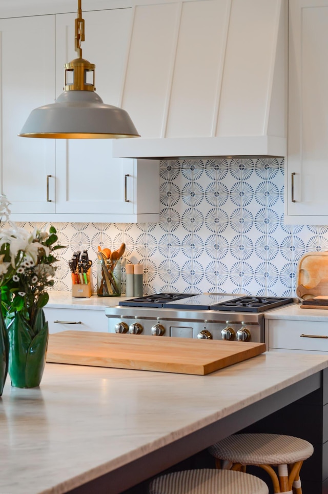 932 Middle St, Sullivans Island, SC 29482 - kitchen featuring custom exhaust hood, white cabinetry, light stone countertops, and tasteful backsplash