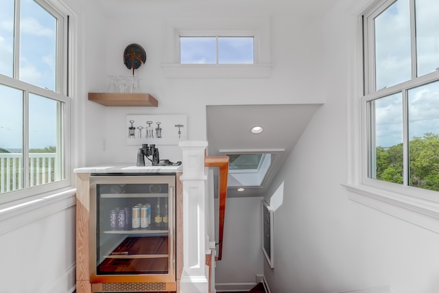 932 Middle St, Sullivans Island, SC 29482 - indoor bar featuring beverage cooler, a towering ceiling, and plenty of natural light