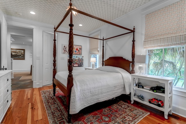 932 Middle St, Sullivans Island, SC 29482 - bedroom with light wood-style flooring, recessed lighting, and ornamental molding